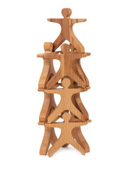 Close-up of a children's toy made of natural wood in the form of little people stand pyramid on a white isolated background. Eco-friendly toy for parents and children