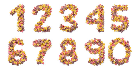 Arabic numerals of the English alphabet from pink colored flakes on a white isolated background. Food pattern made from  sweet breakfast cereals. Bright alphabet for kids shops.