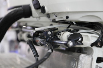 Powerful motor boat transom hydraulic steering of outboard engine close up - steering rod,...