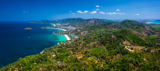 Obraz premium Aerial panorama of the coastline of the island of Phuket with tropical sandy beaches and green mountains. Thailand