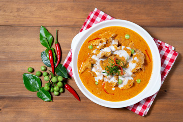 Thai Red curry with pork on wooden background