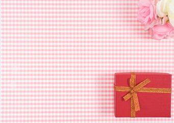 gift box with red isolated on Plaid background. Holiday decoration for Mother's Day or Women's Day.