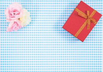 gift box with red isolated on Plaid background. Holiday decoration for Mother's Day or Women's Day.