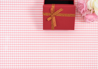 gift box with red isolated on Plaid background. Holiday decoration for Mother's Day or Women's Day.