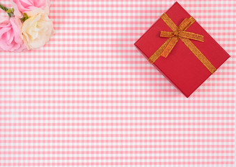 gift box with red isolated on Plaid background. Holiday decoration for Mother's Day or Women's Day.