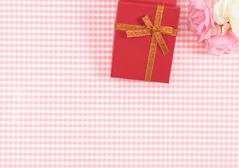 gift box with red isolated on Plaid background. Holiday decoration for Mother's Day or Women's Day.