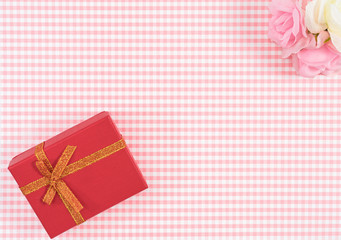 gift box with red isolated on Plaid background. Holiday decoration for Mother's Day or Women's Day.