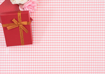 gift box with red isolated on Plaid background. Holiday decoration for Mother's Day or Women's Day.