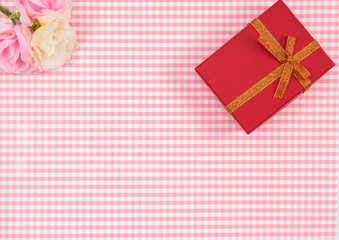 gift box with red isolated on Plaid background. Holiday decoration for Mother's Day or Women's Day.