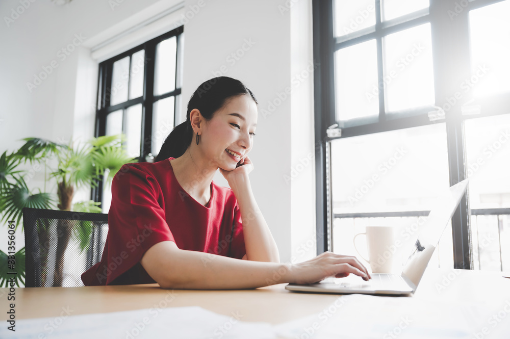 Wall mural portrait of beautiful young asian woman working on laptop in workplace