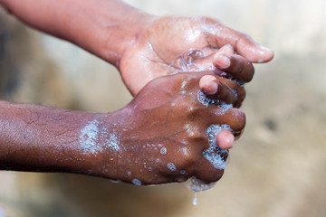 a man washing his hands by soap to maintain hygiene.stay healthy.avoid germ and virus. 