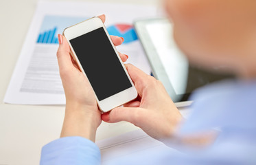 business, technology and people concept - close up of woman with smartphone at office
