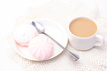 marshmallows, tea or coffee with milk and a tulip flower. on a light background. delicate breakfast, breakfast in bed. for the beloved. Surprise.