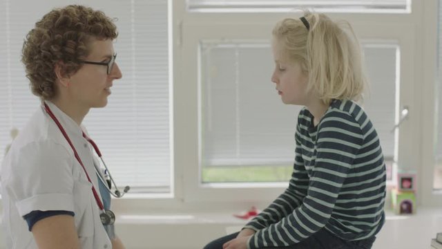 Doctor Shining Torch Into Boy'S Eyes