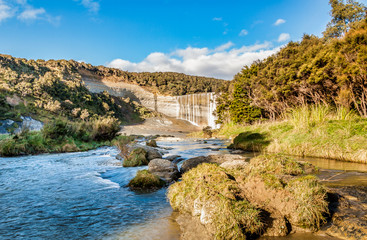 Fototapeta na wymiar Walking up the river through the valley to the base of the spectacular block waterfall Mangatiti falls at Pongaroa Wairarapa New Zealand