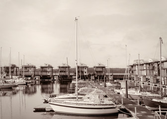 Harbor with sailboats and yachts moored in the port.