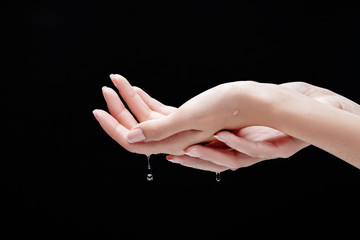 Close up female hands and water drops.