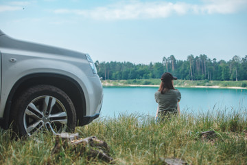 woman sitting on the edge enjoying view of the lake