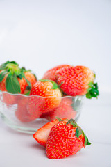 Red fresh strawberry in a bowl isolated on white background