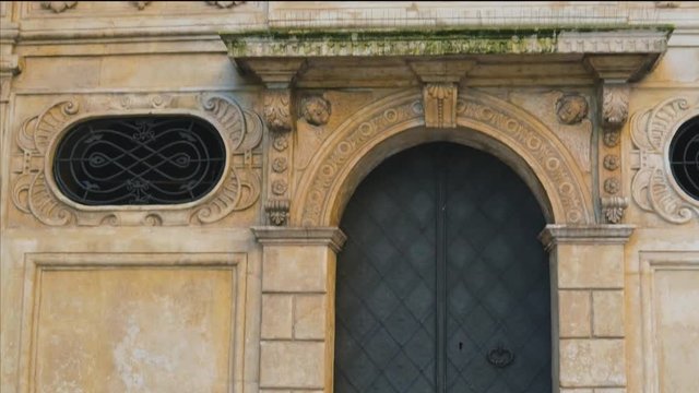 Detail View Of The Facade Of An Old Building With An Iron Gate In Krakow, Poland.-medium shot