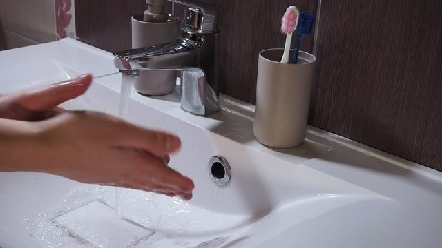 Man Washing His Hands at the Bathroom With Water, Soap. virus like corona virus. Cleaning the skin and have water