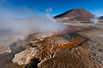 Boiling red mud pools in the geothermal area Sol de Manana in western Bolivia near Uyuni at an elevation of 15,900 feet resembling a landscape on planet mars.