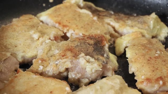 fried fish close-up on a frying pan. selective focus.