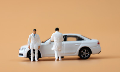 A miniature cars and miniature medical staff.