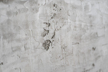 grey wall with rough plaster. the rough surface.