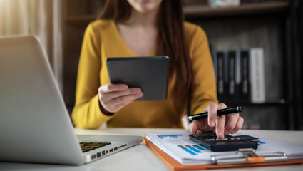 Business and financial concepts about office work. Analysts discuss business with a calculator as a tool.