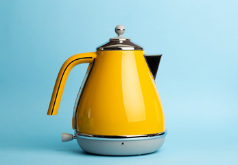 Kettle Background. Electric vintage retro kettle on a colored blue background. Lifestyle and design...