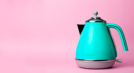 Kettle Background. Electric vintage retro kettle on a colored pink background. Lifestyle and design...