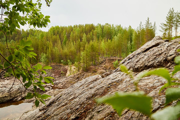 Rocks and rock ledges in the forest in Karelia. Natural landscape in Russia or Finland. The concept of wilderness trip