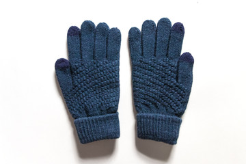 Dark blue knitted touch screen gloves isolated on white background. 