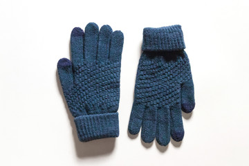 Dark blue knitted touch screen gloves isolated on white background. 