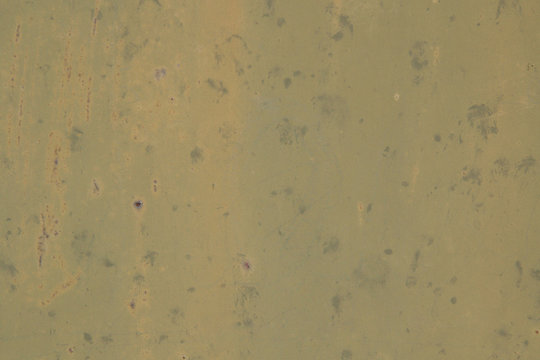 Old khaki background stained and stained, with small dots of rust. Texture vintage swamp color