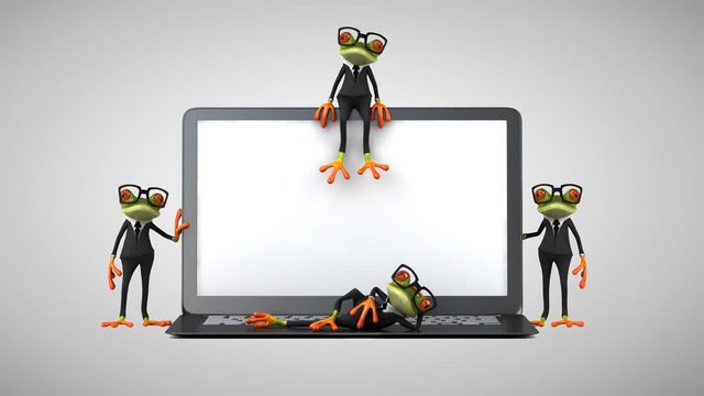 Fun green frogs next to a laptop
