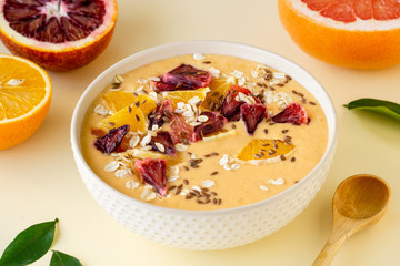 Citrus smoothie bowl with grapefruit and orange on a light background