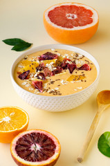 Citrus smoothie bowl with grapefruit and orange on a light background