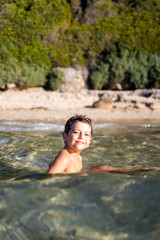 Funny child swimming on the sea