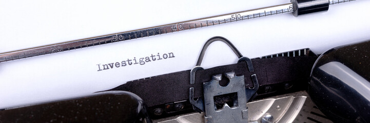 Word Investigation typed on retro black typewriter