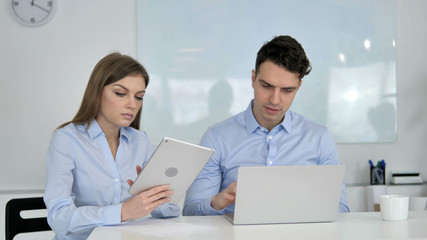 Obraz premium Sharing Opinions, Business Colleagues Using Tablet and Laptop During Work