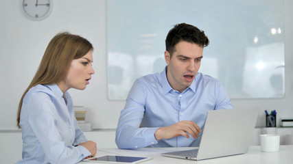 Business People Reacting to Online Financial Loss at Work