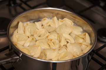 Tortelloni boiling in water in a pan