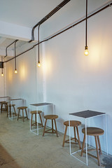 Interior design and decoration of coffee cafe and dining restaurant -decorated with wooden chair and minimal furniture in white wall room
