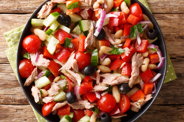 canned tuna salad with fresh vegetables and beans close-up in a plate. horizontal top view