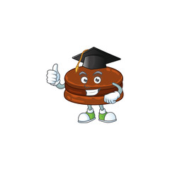 Happy face of chocolate alfajor in black graduation hat for the ceremony