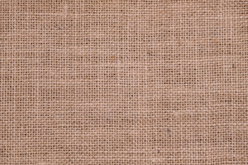 Rough hessian background with flecks of varying colors of beige and brown. with copy space. office desk concept, Hessian sackcloth burlap woven texture background.