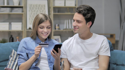 Young Couple Doing Online Shopping on Smartphone