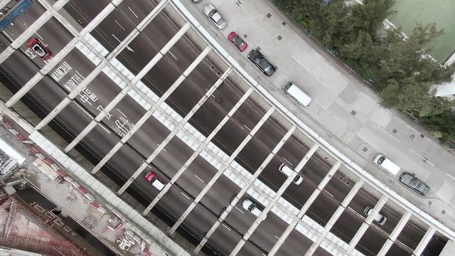 Traffic heading in and out of Cross Harbour Tunnel, Causeway Bay, Downtown Hong Kong, Top down aerial view.